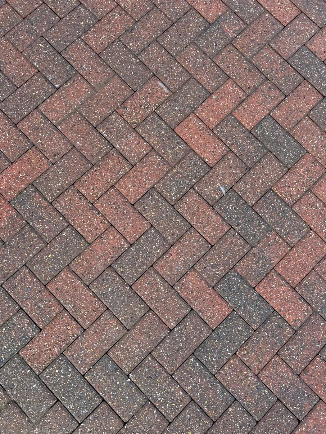 Clean red herringbone block paving