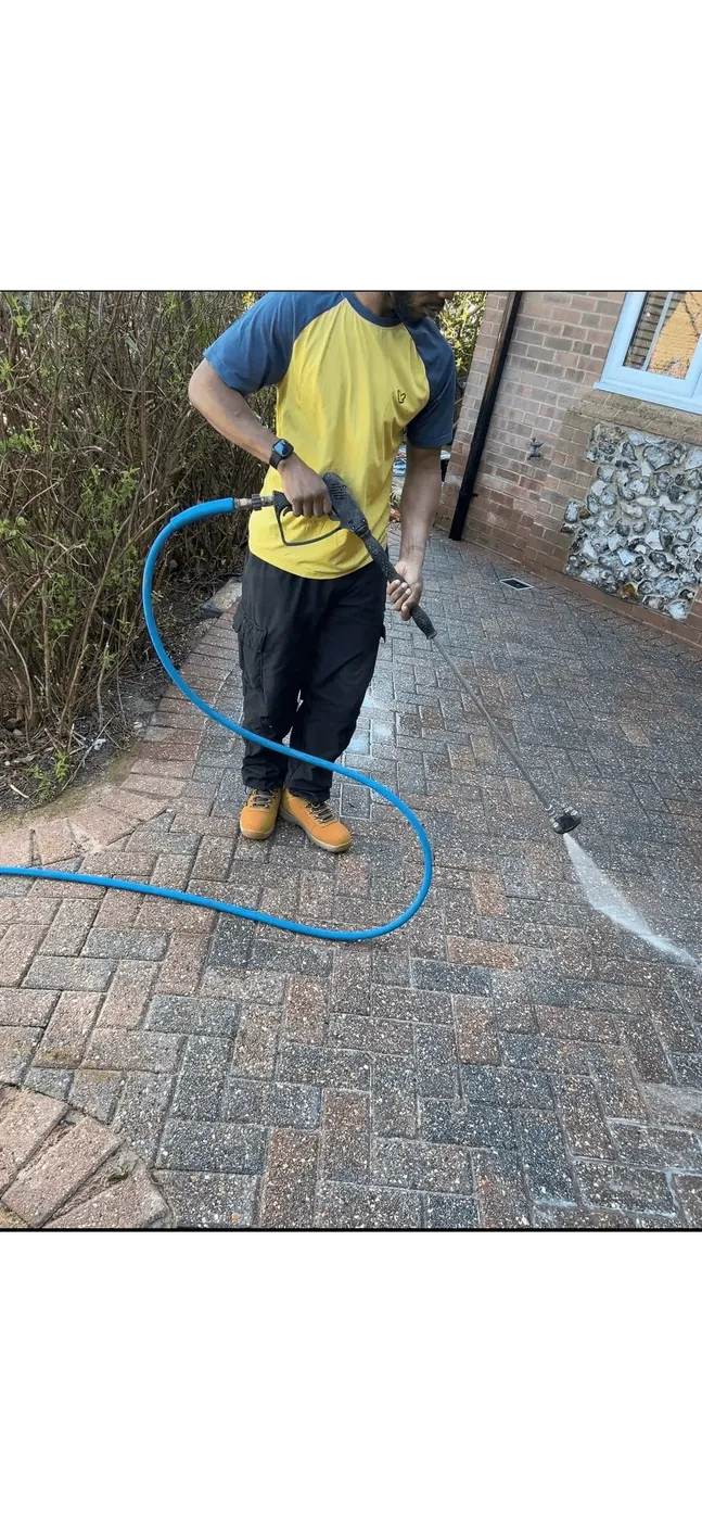 Operative pressure washing a block-paved driveway